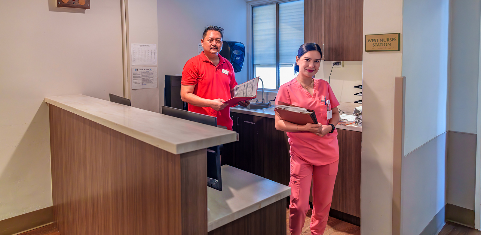 Two nurses at station.